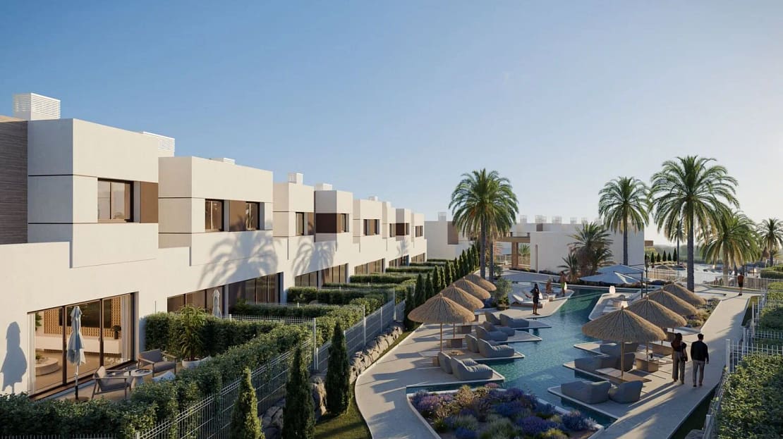 Aerial rear view of connected luxury cube-shaped villas with a sleek swimming pool, sunbeds, and palm trees